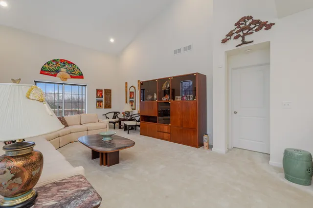 a living room with furniture a rug and a large window