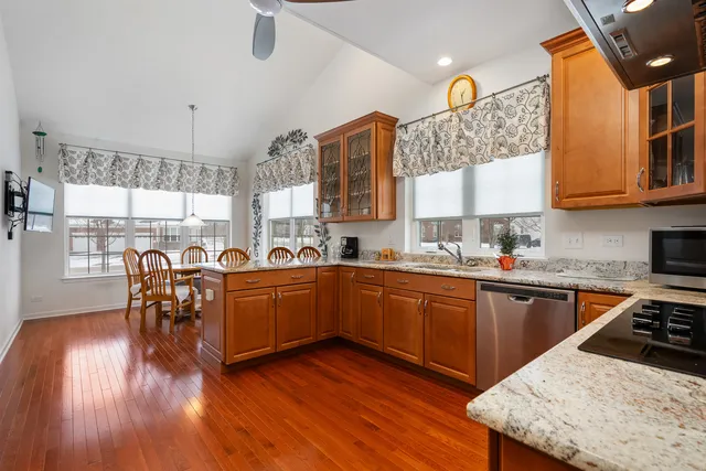a kitchen with a table chairs sink and cabinets