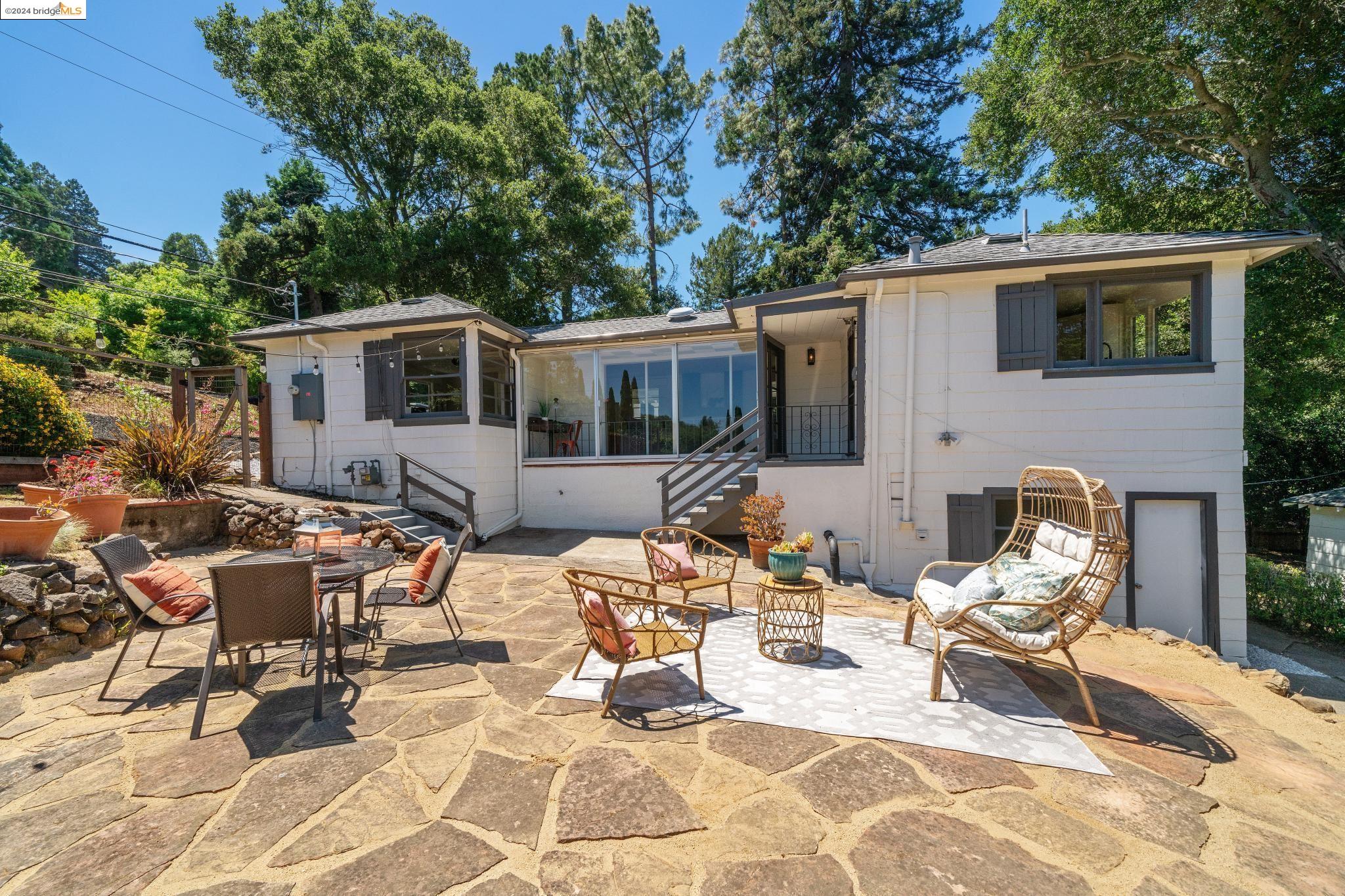 a view of a patio with couches table and chairs and potted plants