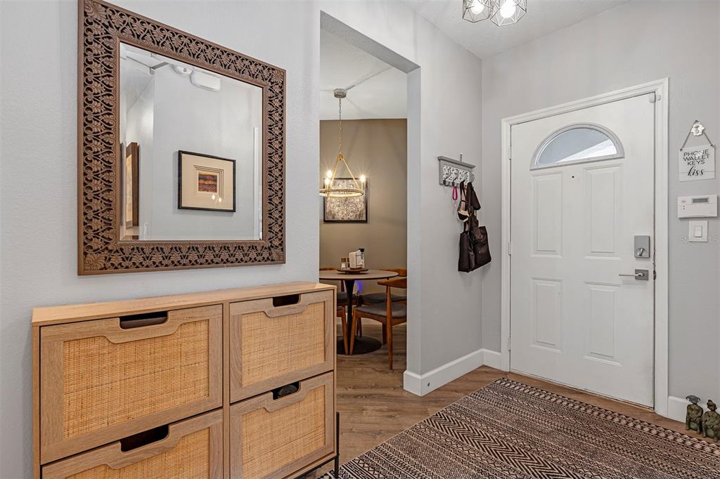 550 Cranes Way, Unit 120 Altamonte Springs, FL 32701 - Photo 3 of 32 a view of a hallway with wooden floor and a bathroom