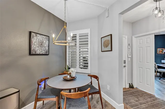 a kitchen with stainless steel appliances granite countertop a stove a sink dishwasher and a microwave oven with white cabinets