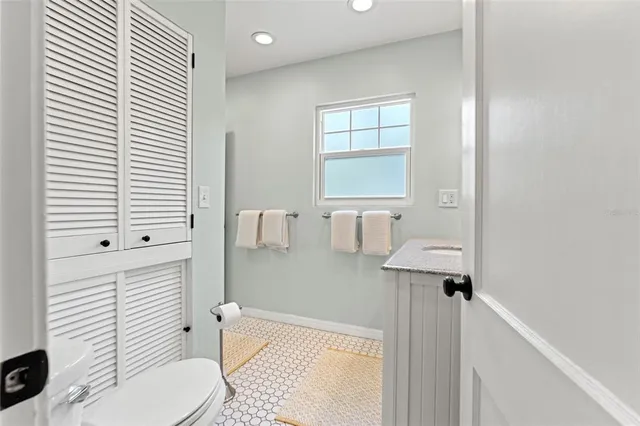 a bathroom with a toilet a sink and mirror