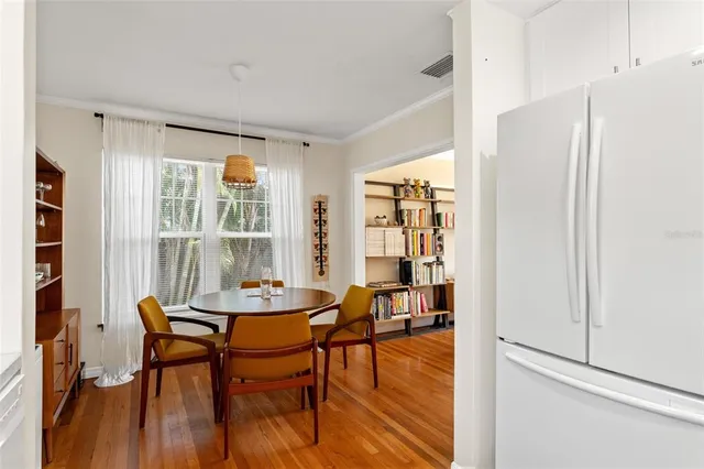 a dining room with furniture and window