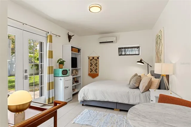 a living room with furniture and a floor to ceiling window