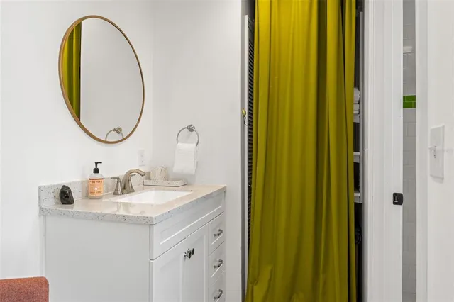 a white toilet sitting next to a bathroom sink