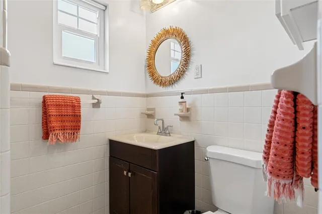 a bathroom with a glass door shower and a sink