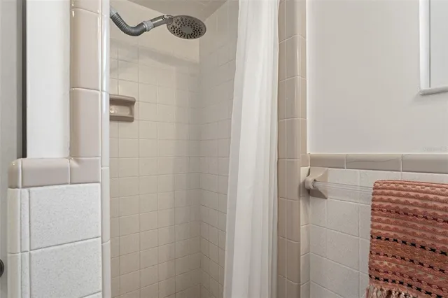 a kitchen with stainless steel appliances refrigerator dining table and chairs