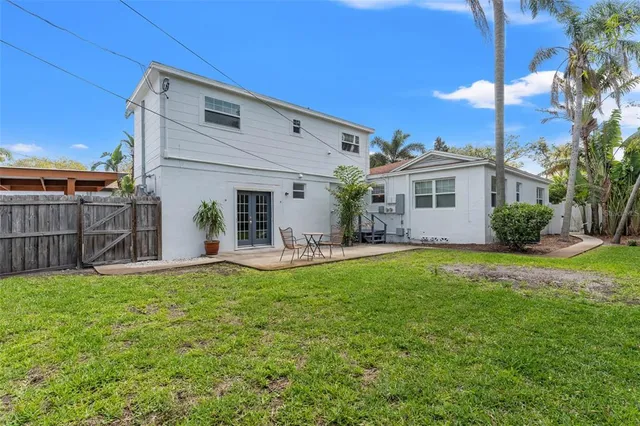 a view of backyard with wooden deck and furniture
