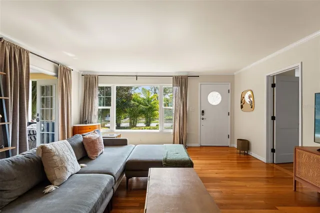a bedroom with furniture and a large window