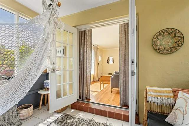 a view of a hallway with wooden floor and a livingroom view