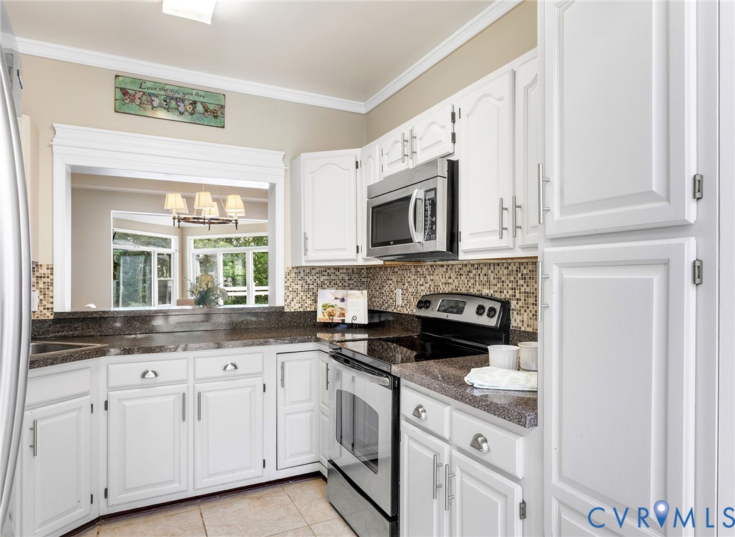 318 Water Pointe Lane Midlothian, VA 23112 - Photo 13 of 50 a kitchen with granite countertop white cabinets and white appliances