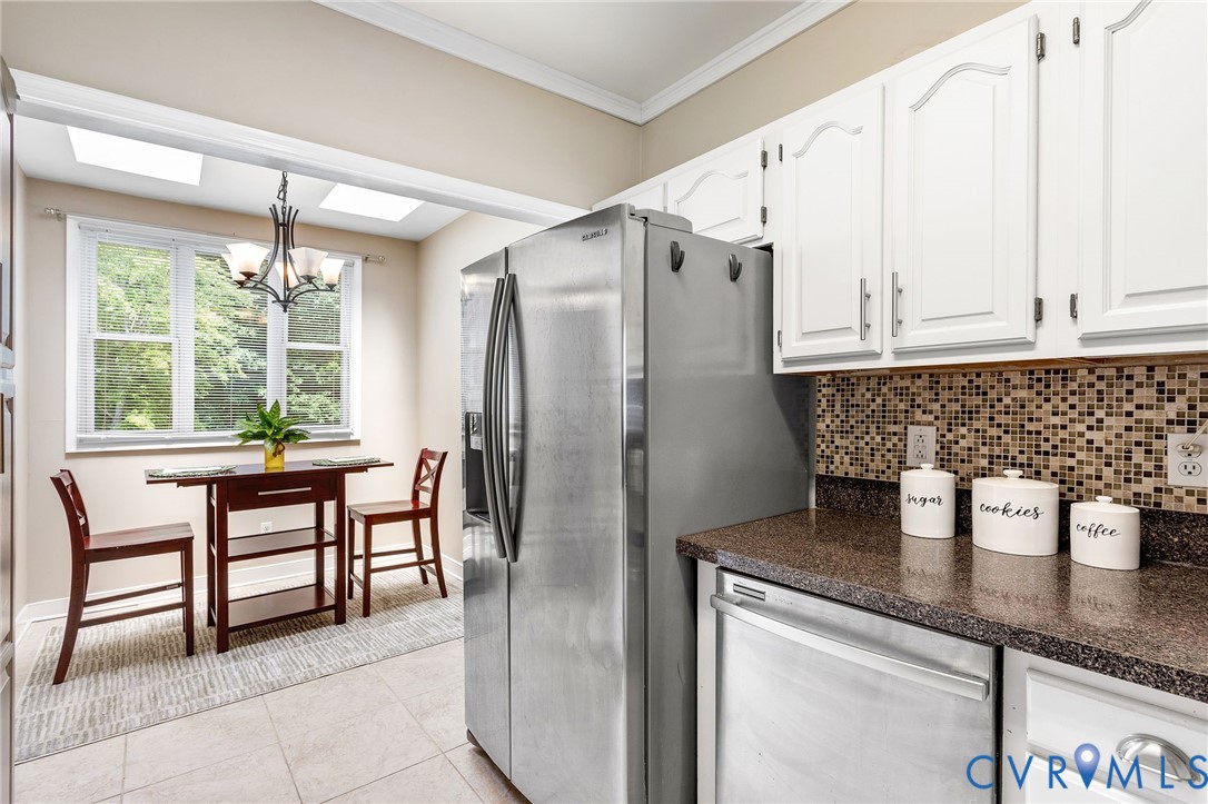 318 Water Pointe Lane Midlothian, VA 23112 - Photo 15 of 50 a kitchen with stainless steel appliances granite countertop a refrigerator a sink a stove and white cabinets with wooden floor
