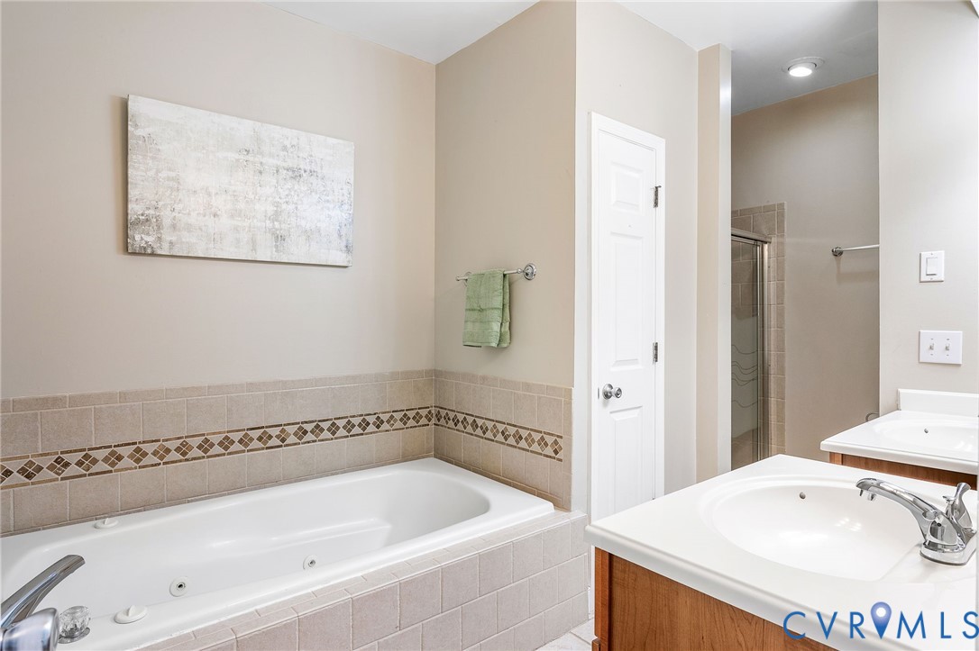 318 Water Pointe Lane Midlothian, VA 23112 - Photo 19 of 50 a bathroom with a tub a sink and mirror
