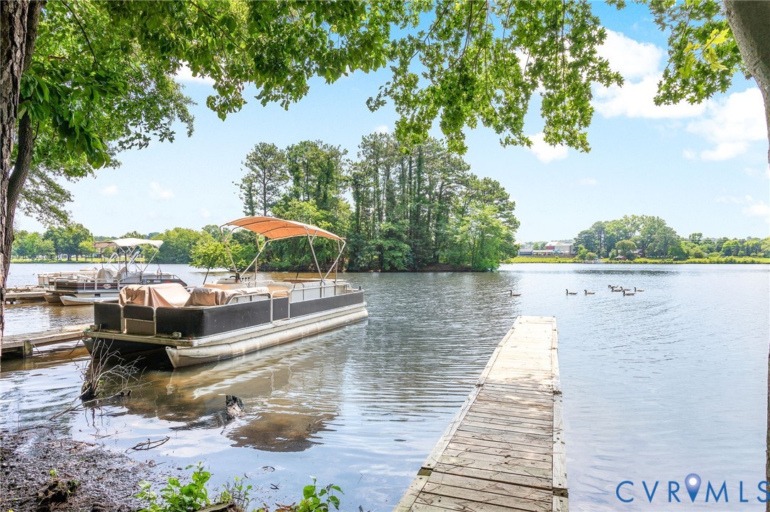 318 Water Pointe Lane Midlothian, VA 23112 - Photo 28 of 50 a wooden pier with boats and trees in the background