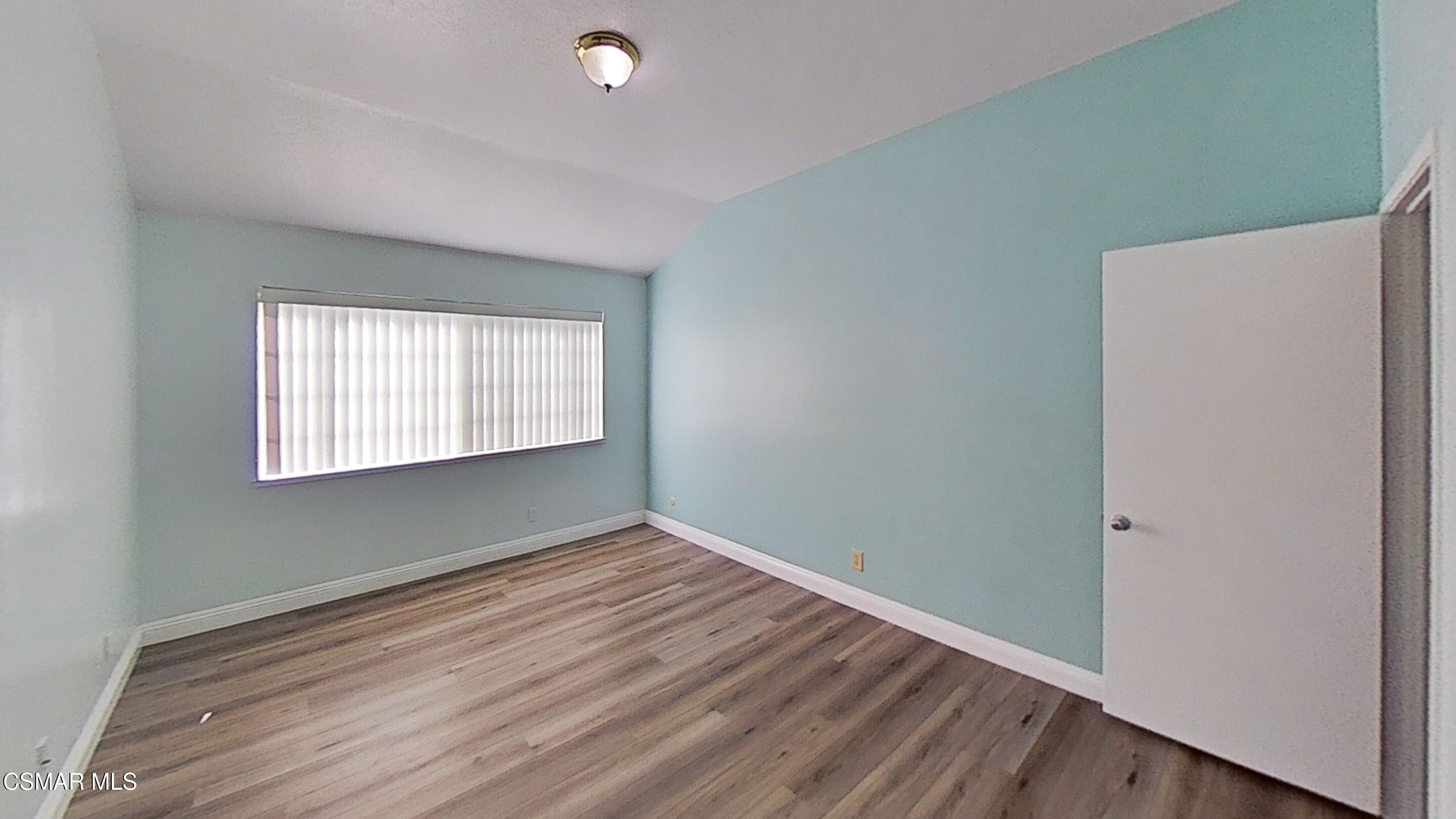 652 Harper Street Simi Valley, CA 93065 - Photo 15 of 30 a view of an empty room with wooden floor and a window