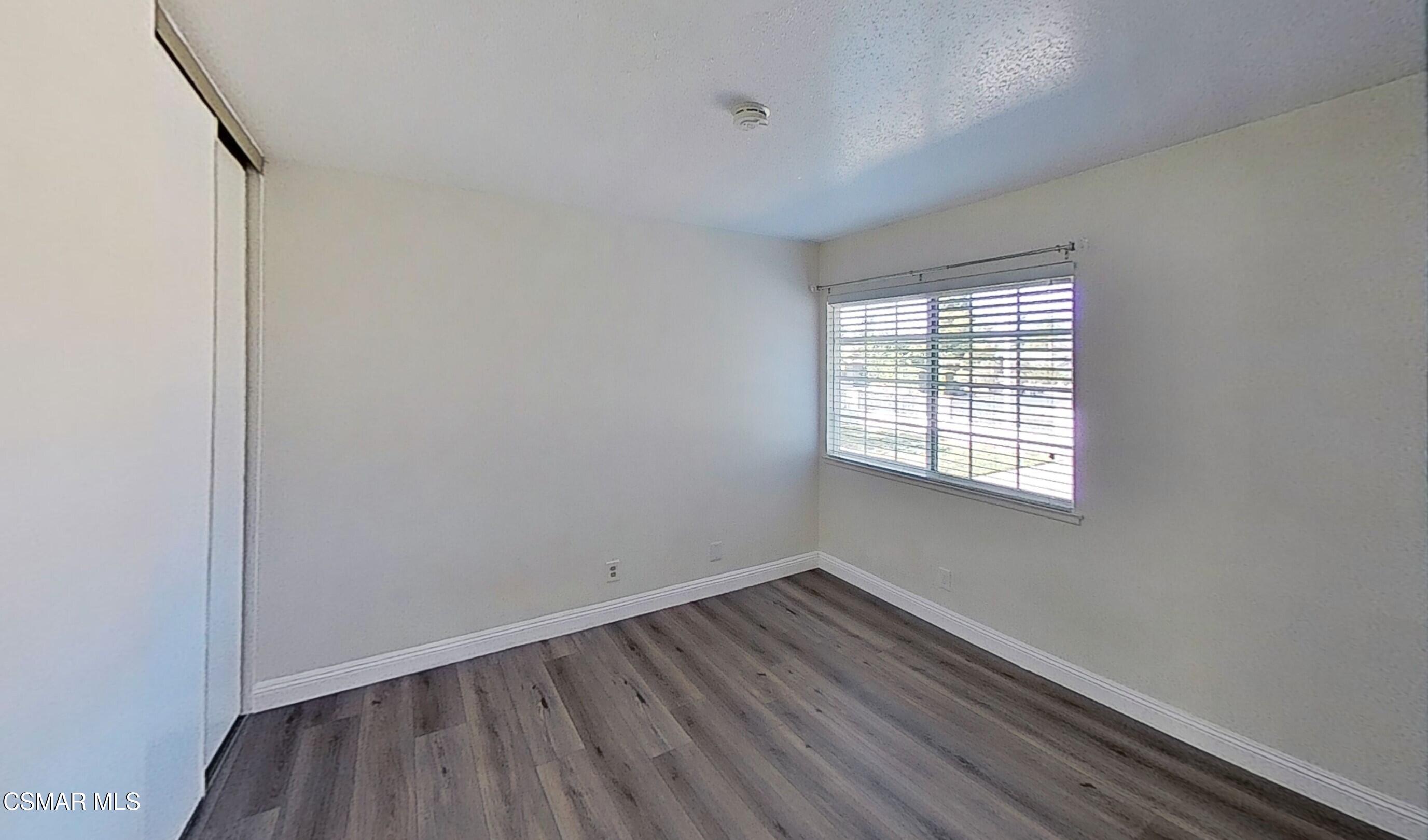 652 Harper Street Simi Valley, CA 93065 - Photo 23 of 30 an empty room with wooden floor and windows