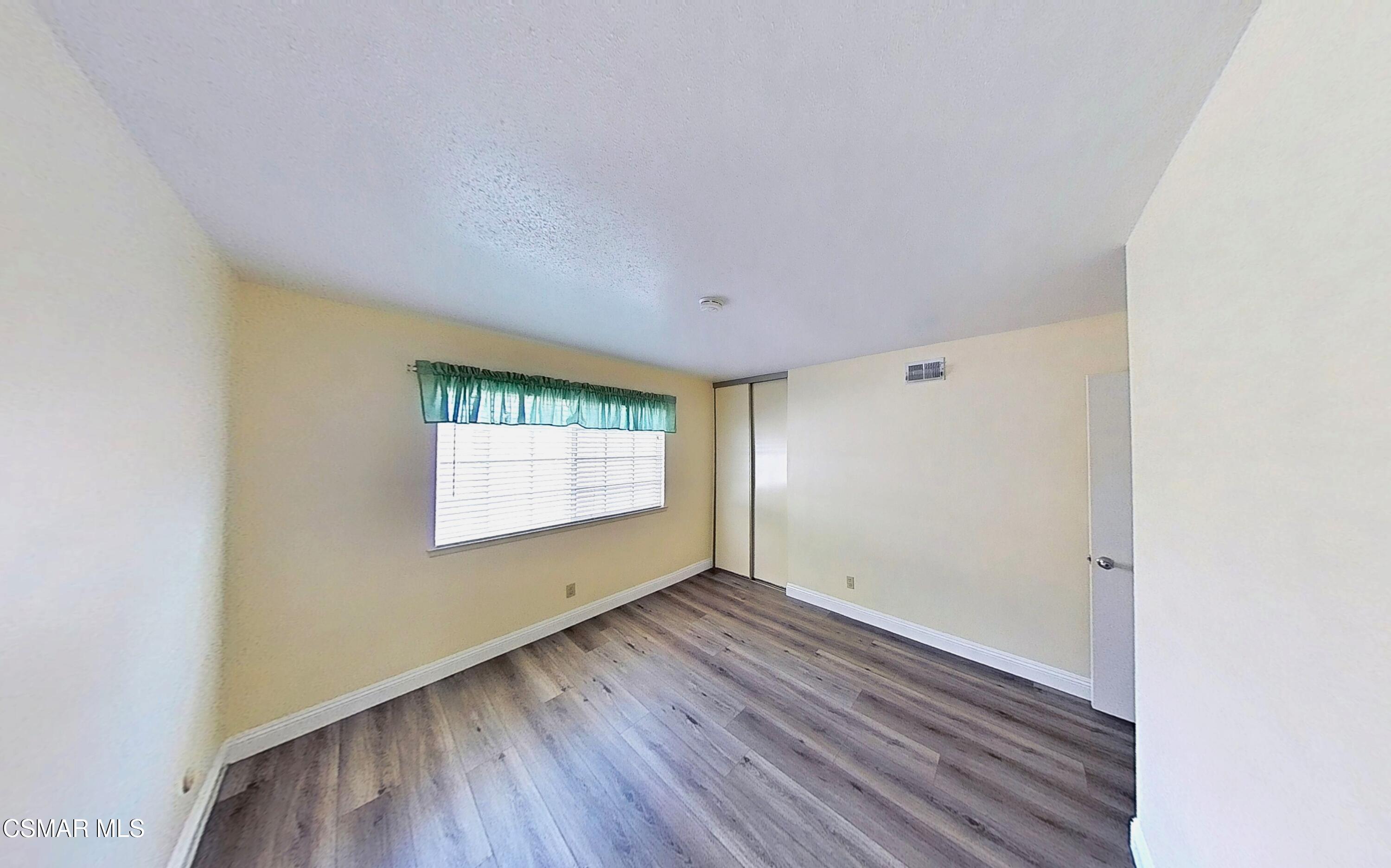 652 Harper Street Simi Valley, CA 93065 - Photo 24 of 30 an empty room with wooden floor and windows