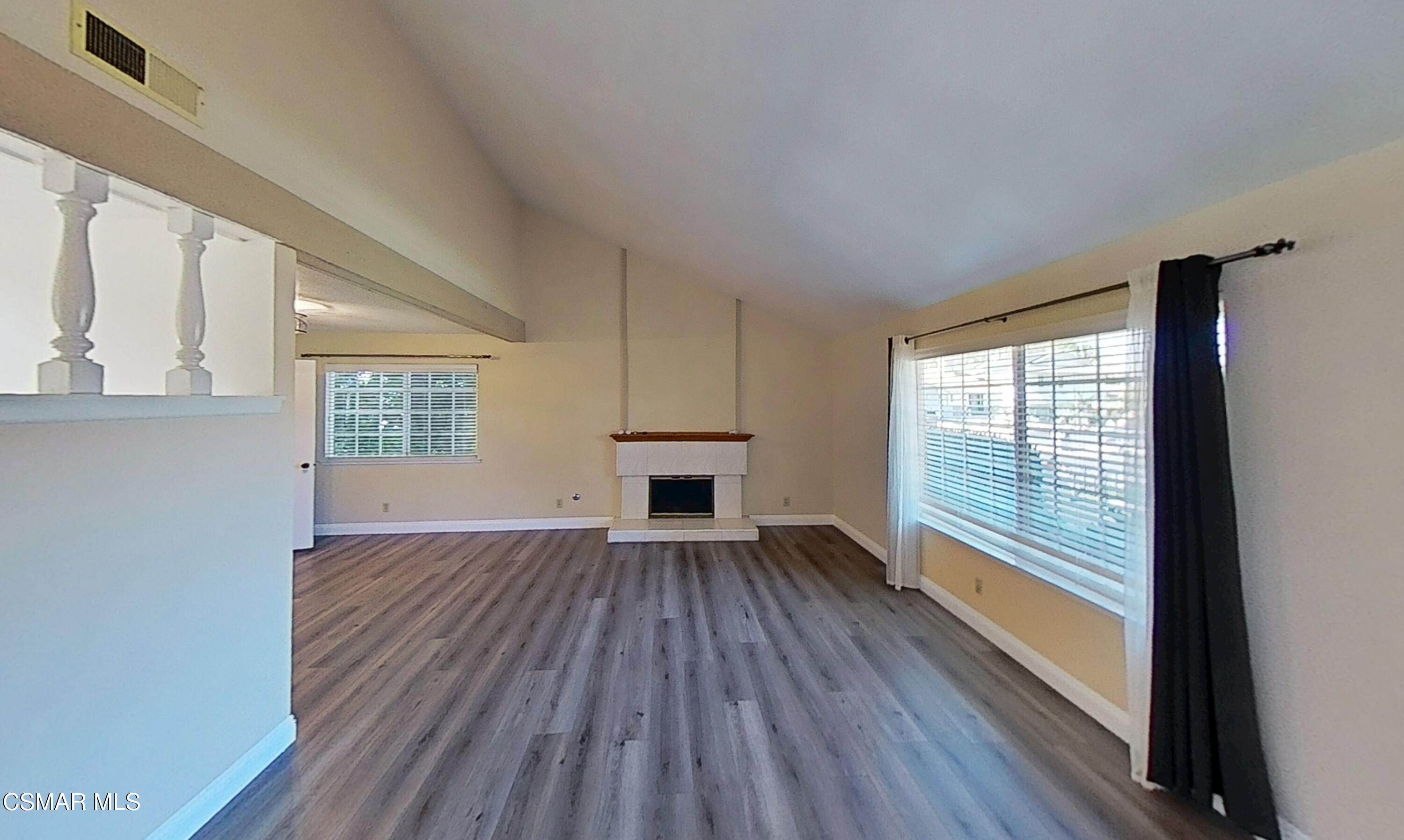 652 Harper Street Simi Valley, CA 93065 - Photo 3 of 30 a view of an empty room with wooden floor and a window