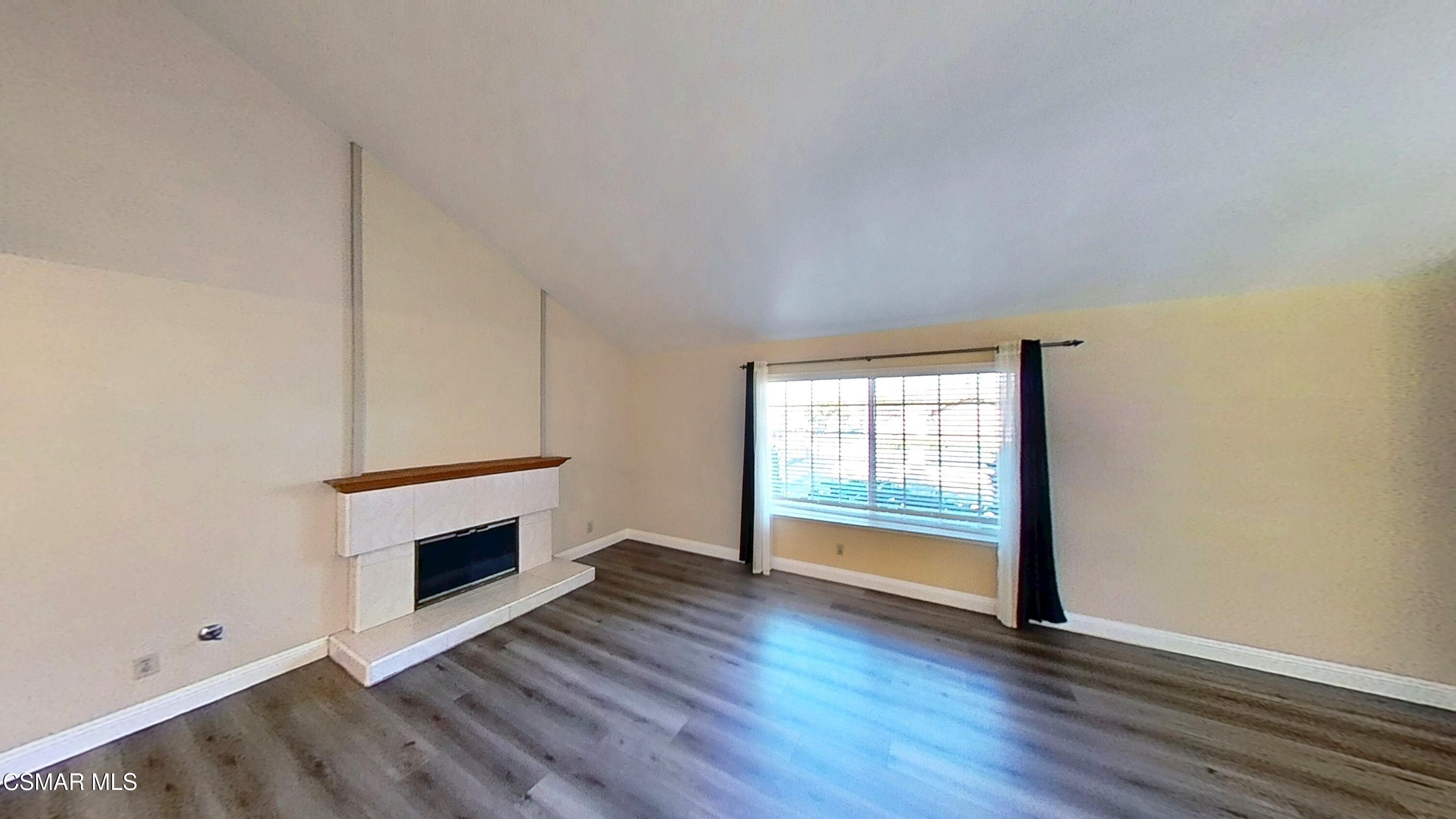 652 Harper Street Simi Valley, CA 93065 - Photo 4 of 30 an empty room with wooden floor and fireplace