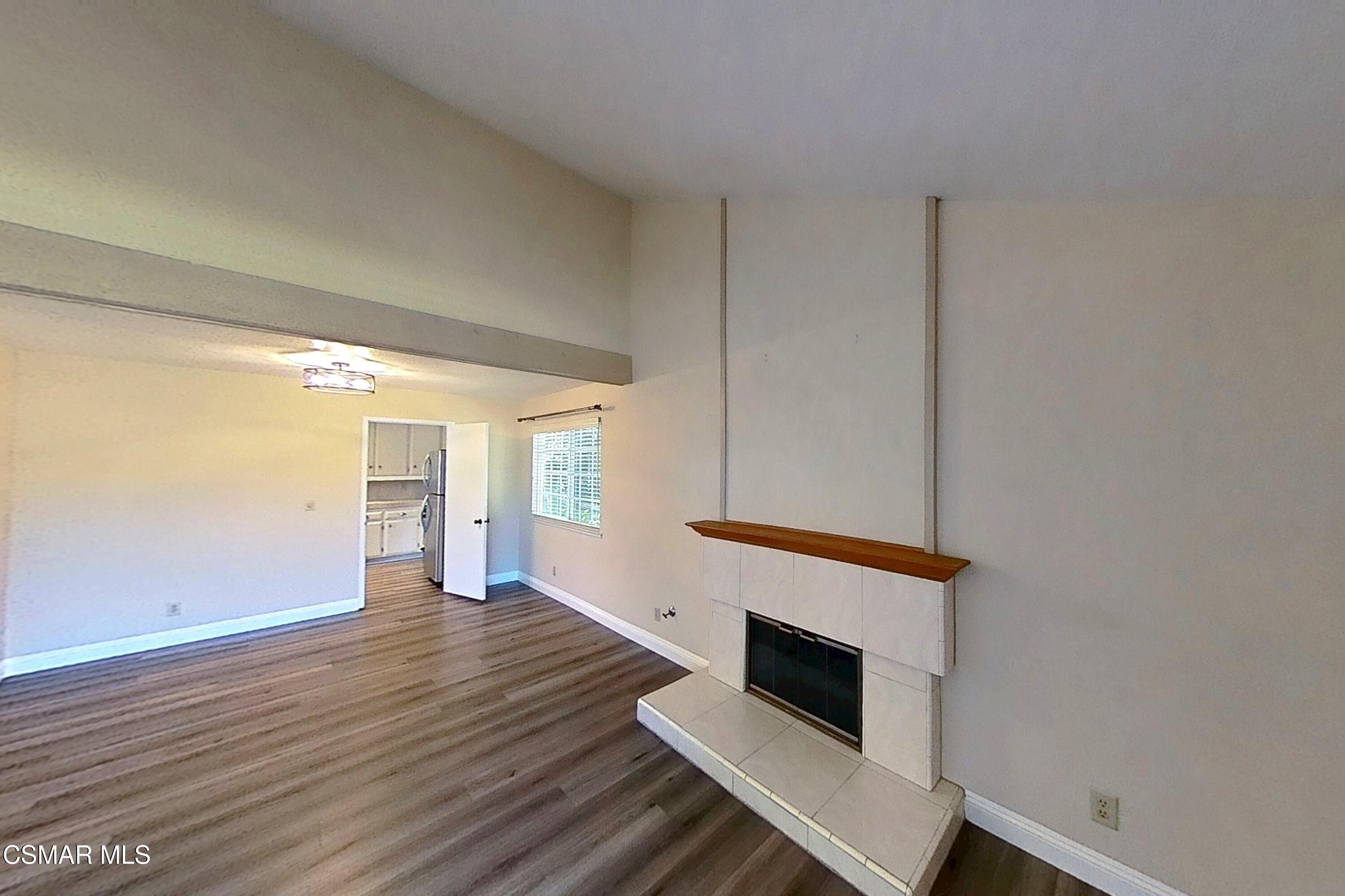 652 Harper Street Simi Valley, CA 93065 - Photo 5 of 30 an empty room with wooden floor fireplace and windows