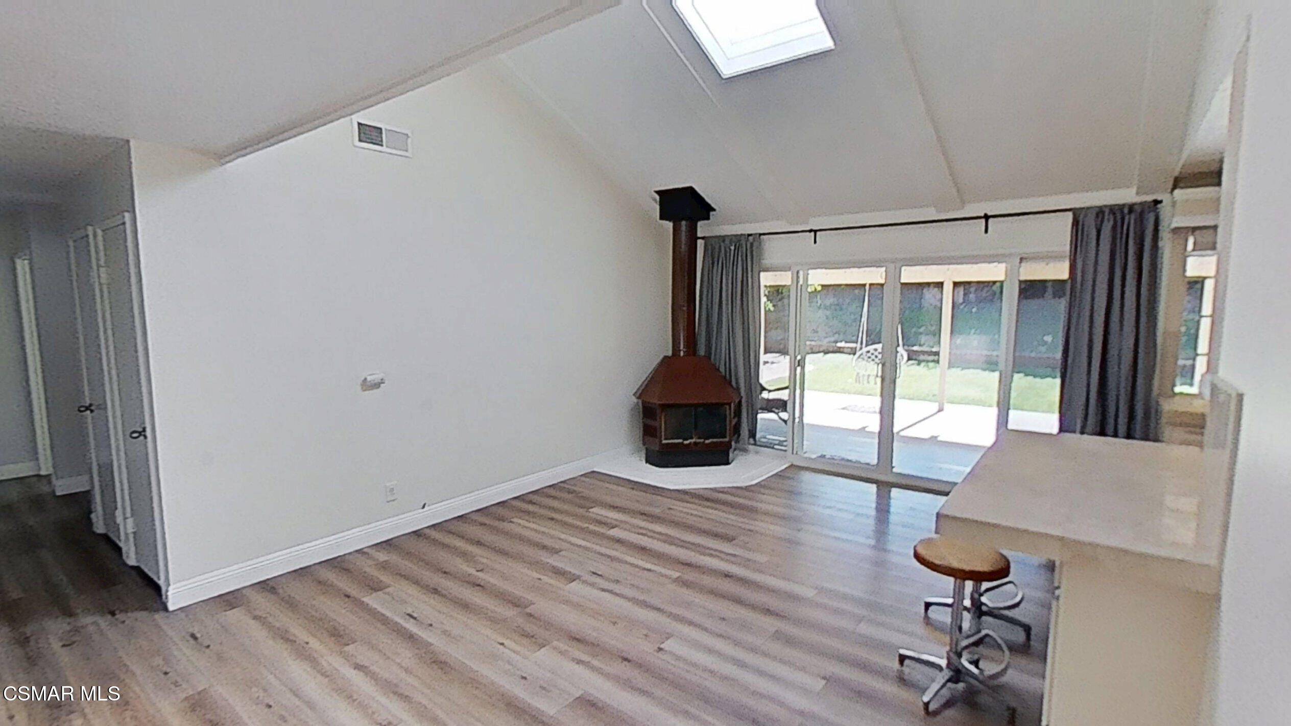 652 Harper Street Simi Valley, CA 93065 - Photo 7 of 30 a room with wooden floor and a view of bedroom with furniture