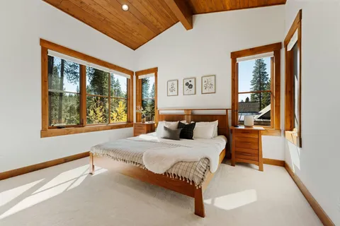 a bedroom with a large bed and a window