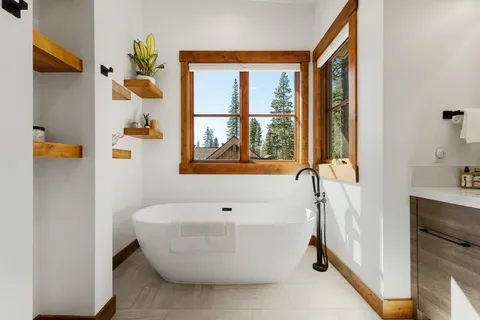 a white bath tub sitting next to a bathroom