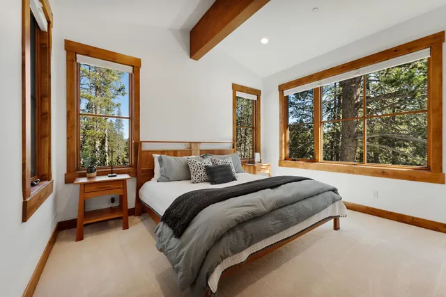 a bedroom with a large bed and a large window