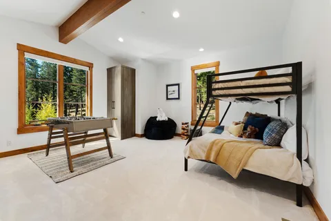 a bedroom with a bed and a large window