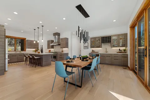 a view of a dining room with furniture and a kitchen