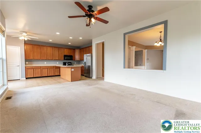 a view of a kitchen with a sink and a refrigerator