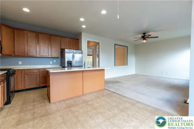 a kitchen with granite countertop a stove sink and cabinets