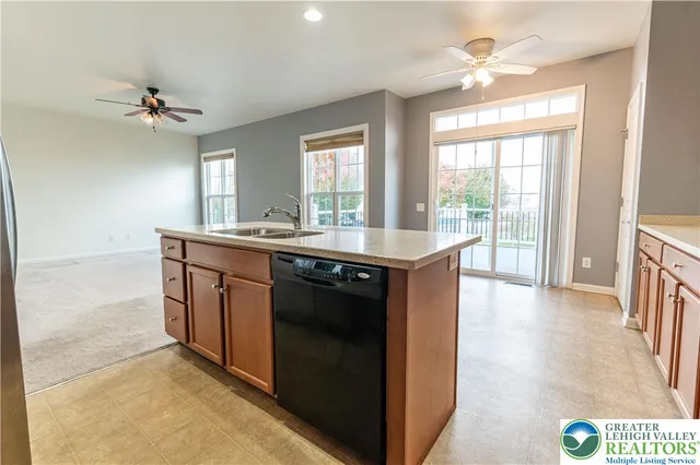 a kitchen with a sink appliances and a counter top space