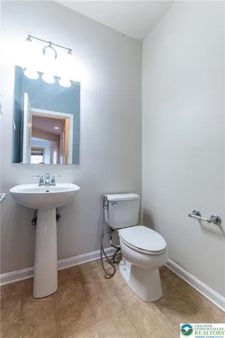 a bathroom with a sink toilet and a mirror