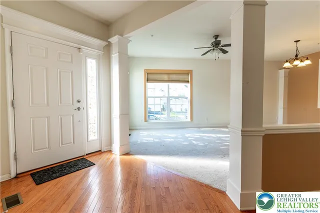a view of empty room with window and cabinet