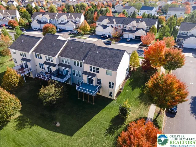 an aerial view of residential houses with outdoor space