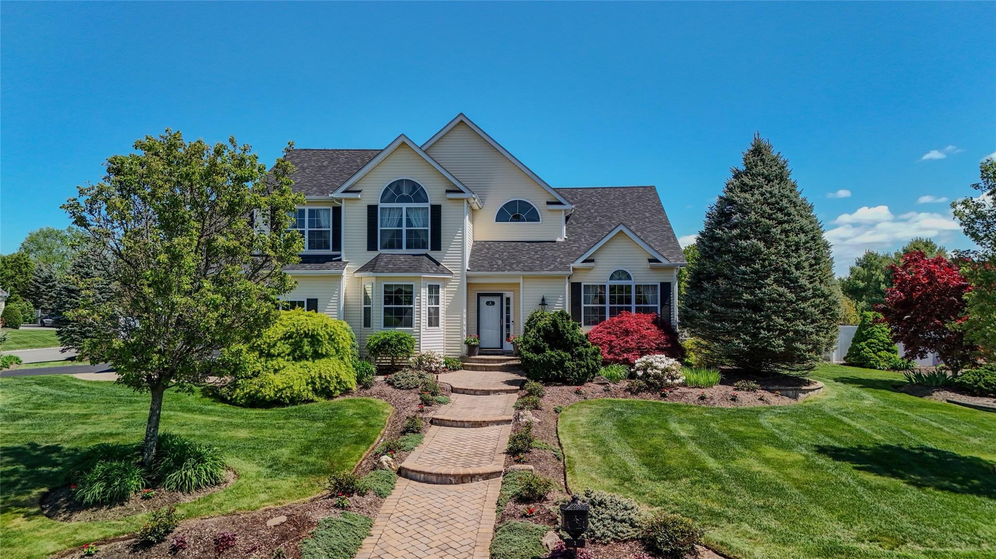 a front view of a house with garden
