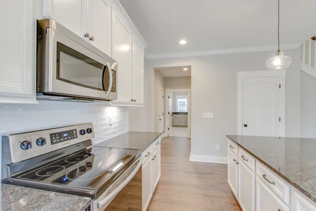 a kitchen with a stove microwave and sink