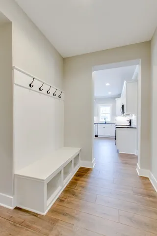 a view of a kitchen with wooden floor and a sink
