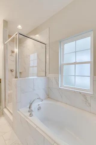 a bathroom with a bathtub and a shower