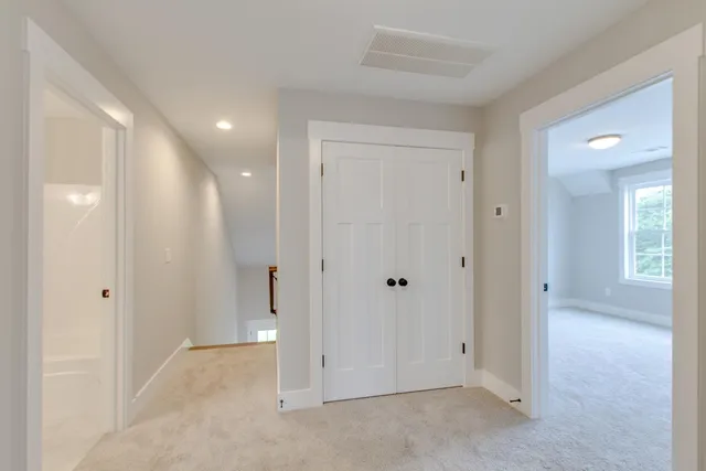 a view of an empty room and a bathroom