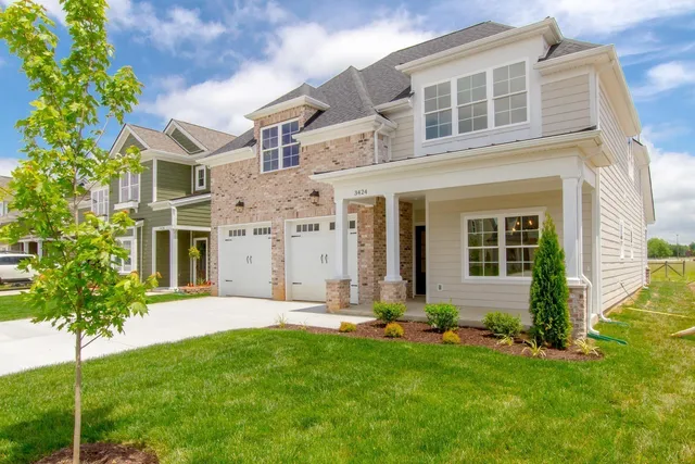 a front view of a house with a yard and garage
