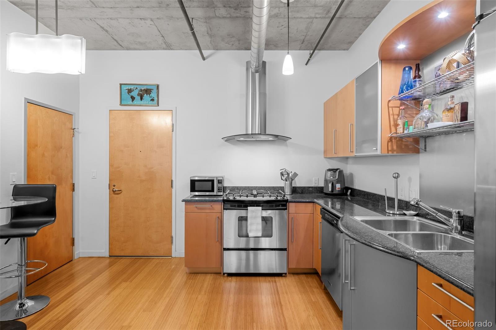 1401 Wewatta Street, Unit 311 Denver, CO 80202 - Photo 12 of 34 a kitchen with stainless steel appliances granite countertop a sink a stove and a refrigerator