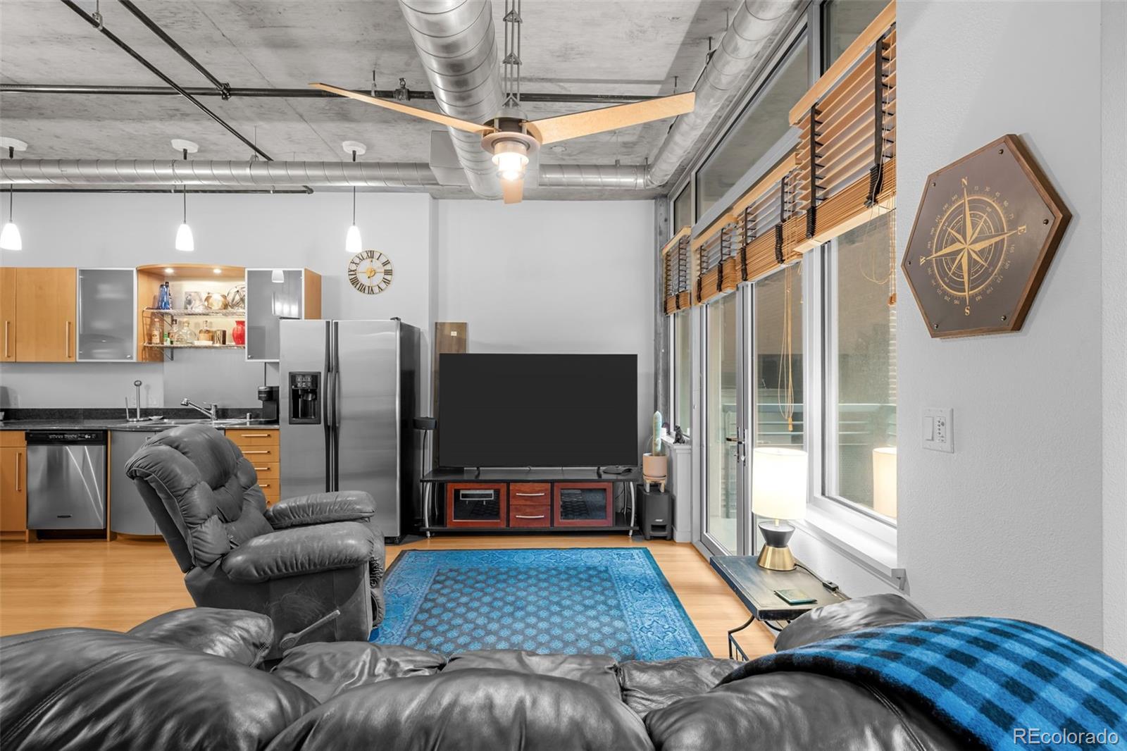 1401 Wewatta Street, Unit 311 Denver, CO 80202 - Photo 19 of 34 a living room with furniture and a flat screen tv