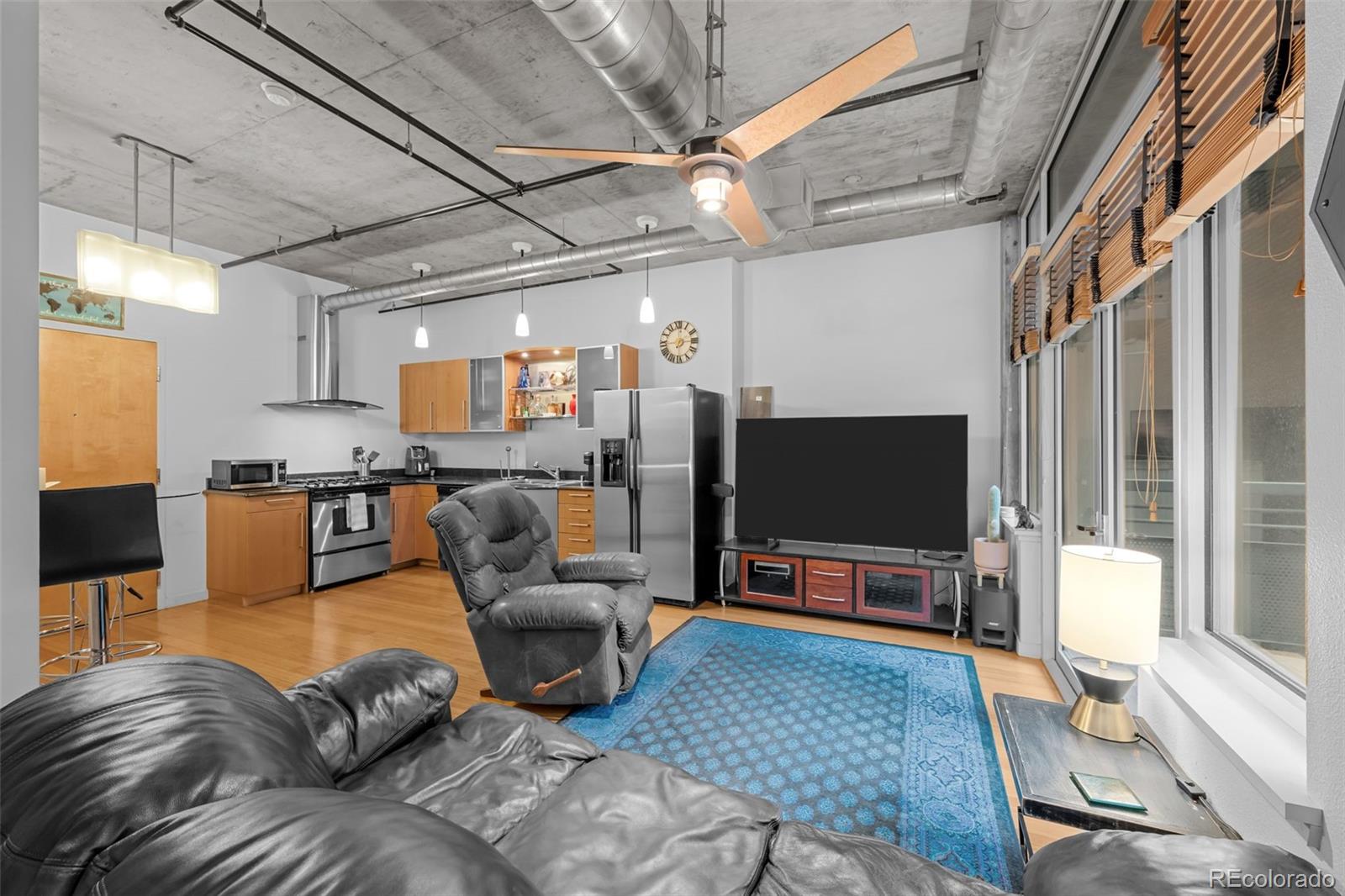 1401 Wewatta Street, Unit 311 Denver, CO 80202 - Photo 20 of 34 a living room with furniture and a flat screen tv