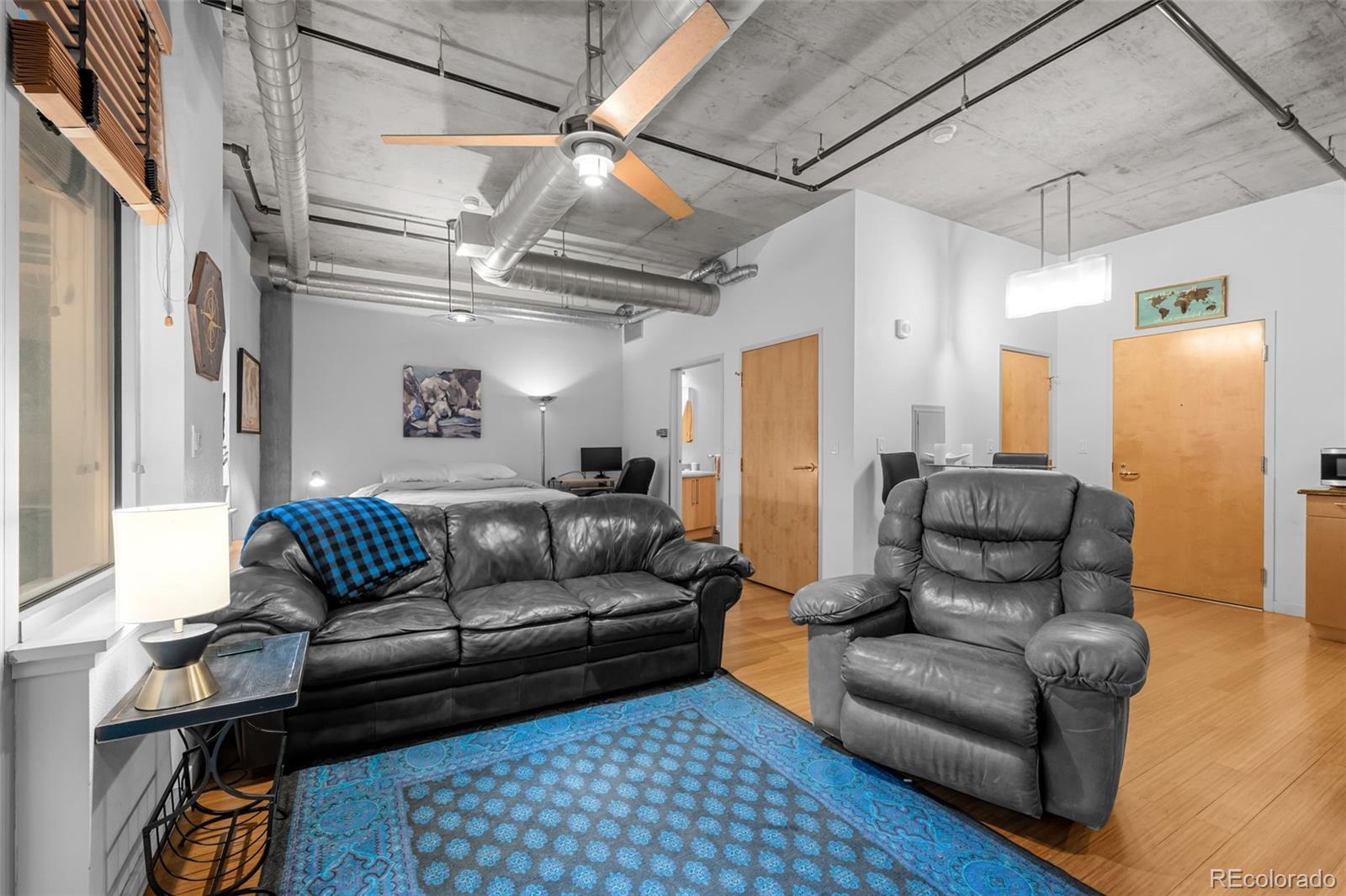 1401 Wewatta Street, Unit 311 Denver, CO 80202 - Photo 21 of 34 a living room with furniture and a chandelier