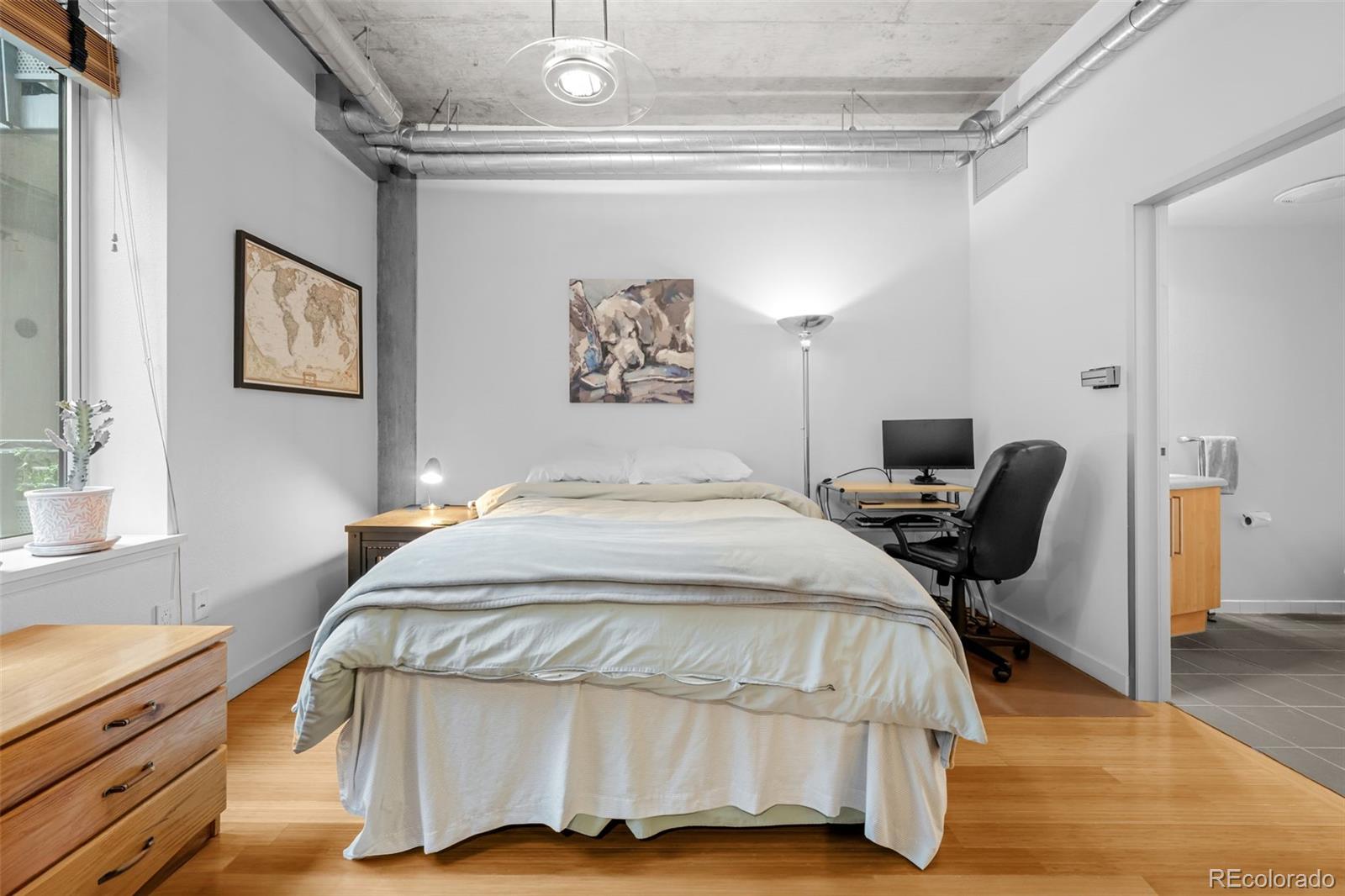 1401 Wewatta Street, Unit 311 Denver, CO 80202 - Photo 23 of 34 a bedroom with a bed and furniture