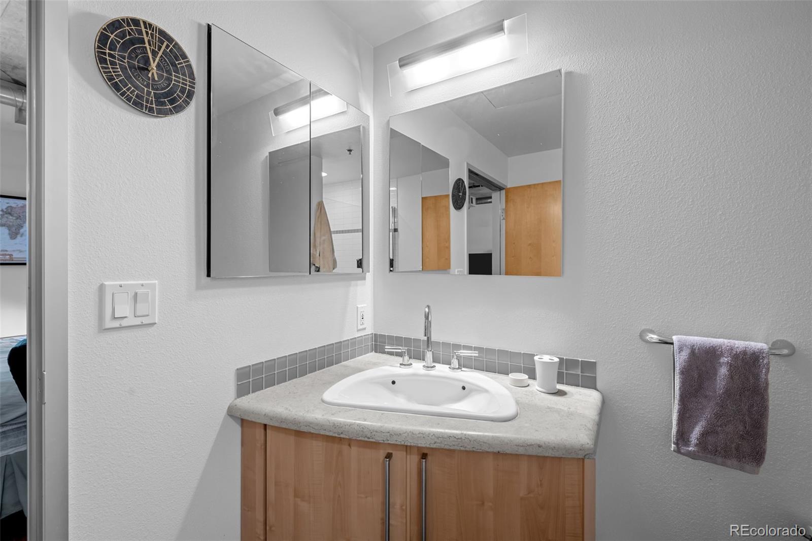 1401 Wewatta Street, Unit 311 Denver, CO 80202 - Photo 26 of 34 a bathroom with a sink and a mirror