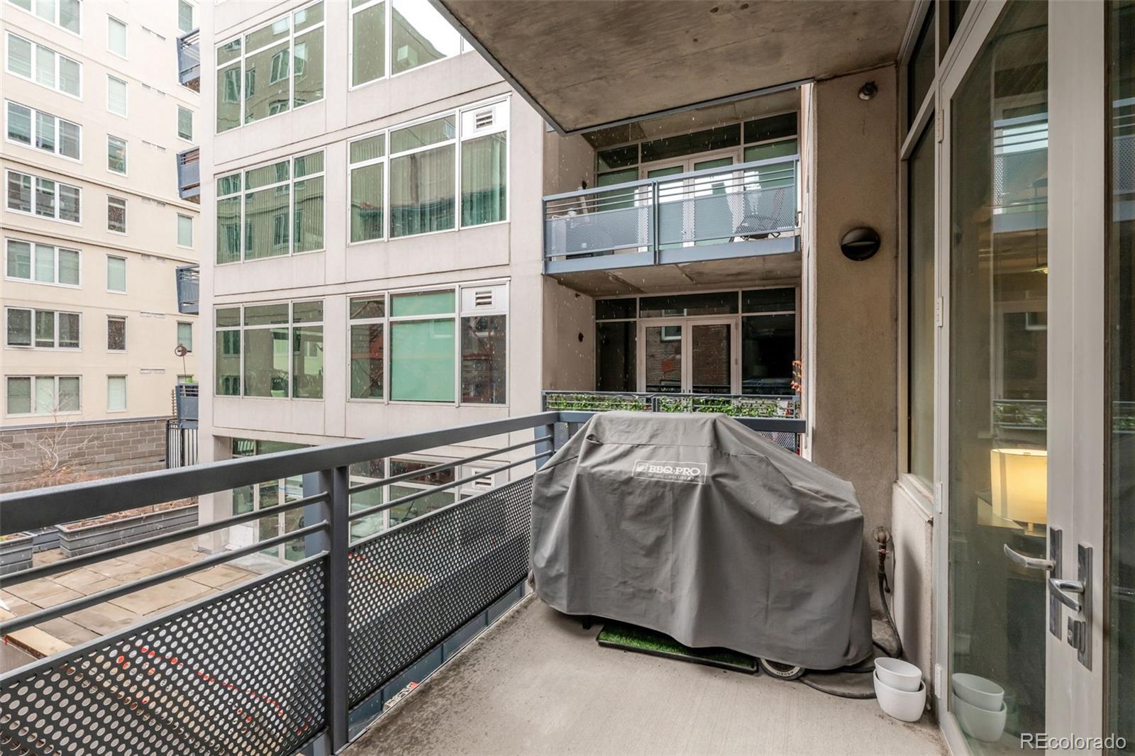 1401 Wewatta Street, Unit 311 Denver, CO 80202 - Photo 28 of 34 a balcony with wooden floor and furniture