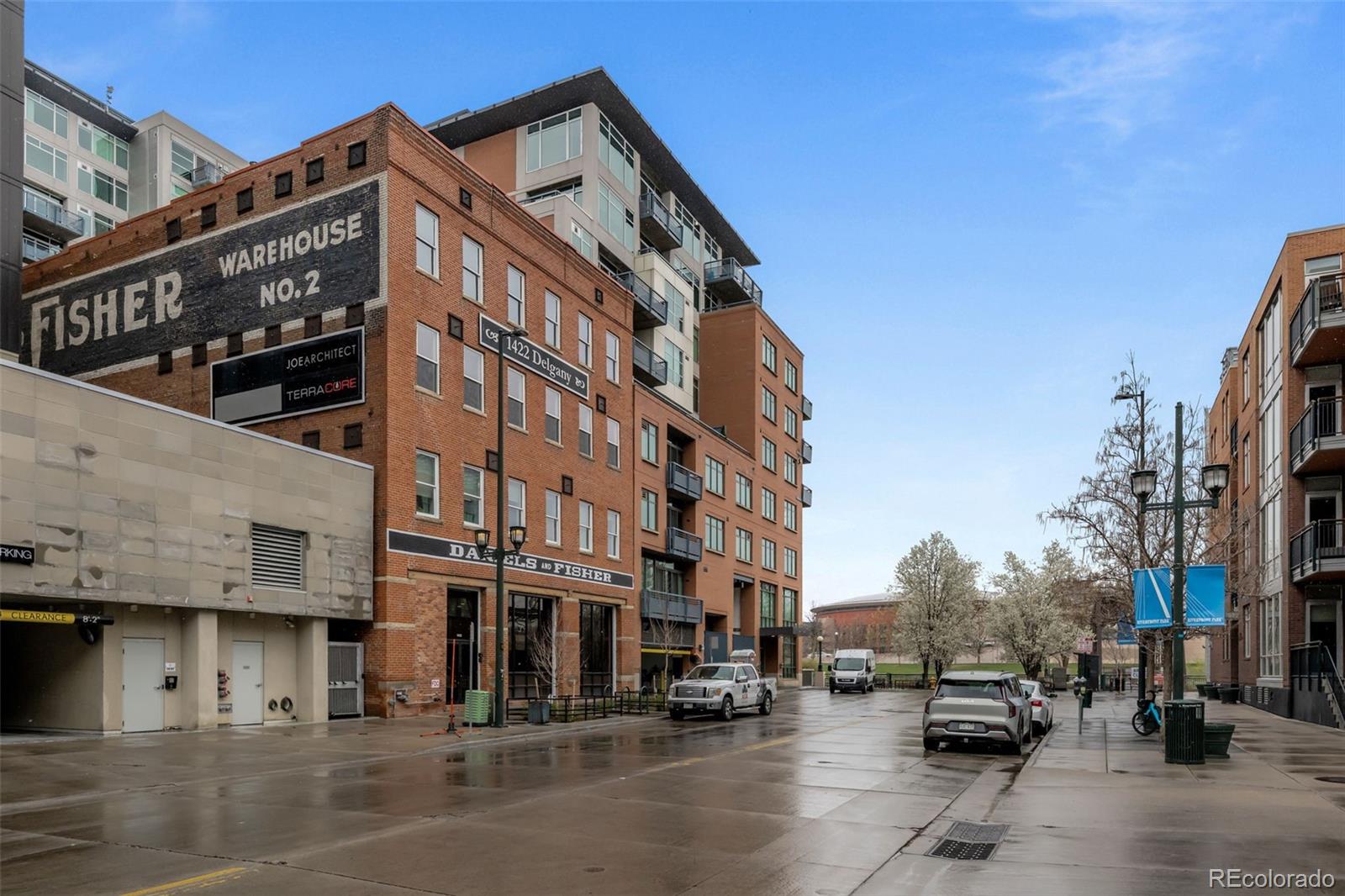 1401 Wewatta Street, Unit 311 Denver, CO 80202 - Photo 32 of 34 a city street lined with buildings and cars